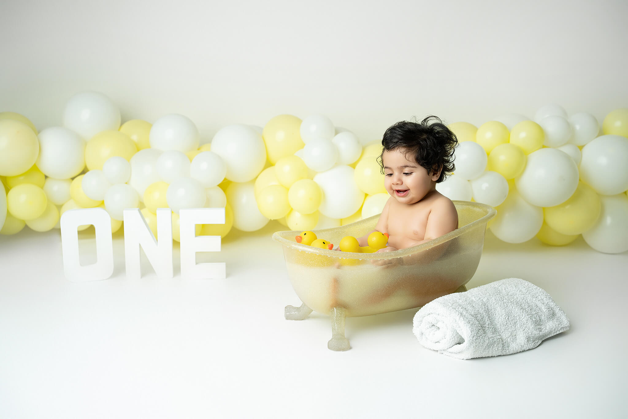 Smash the cake fotografering Stockholm – liten flicka med gul och vit tårta